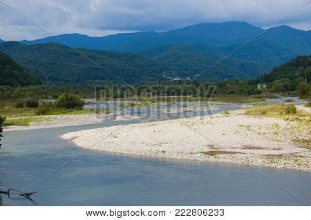 The mountain river Shahe in the south of Russia. The blue sky. Lazarevskoye.Golovinka