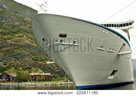 Passenger ship in port Flam, Norway. Luxury cruise ship docked in port Flom, Norway. Front view of liner ship.