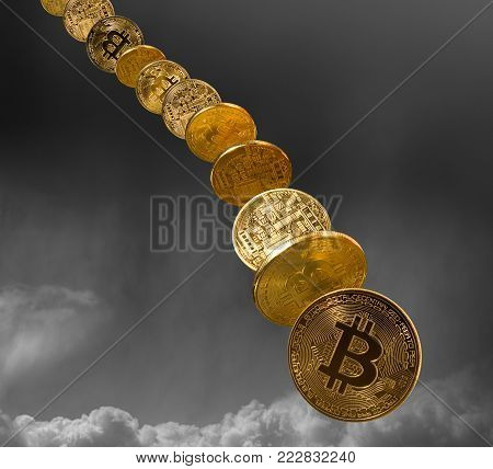 Bitcoin coins falling from the sky to illustrate the falling price of the cybercurrency