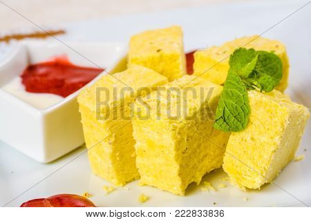 Indian sweet dessert. Soan Papdi on white plate