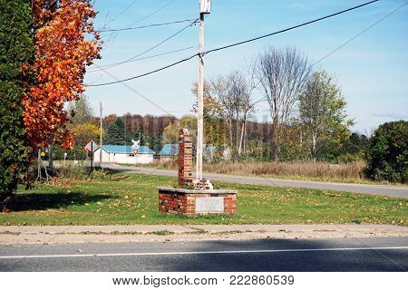 ALBA, MICHIGAN / UNITED STATES - OCTOBER 22, 2017: A brick monument, outside the Alba United Methodist Church, serves as a memorial to Orville F. Walker.