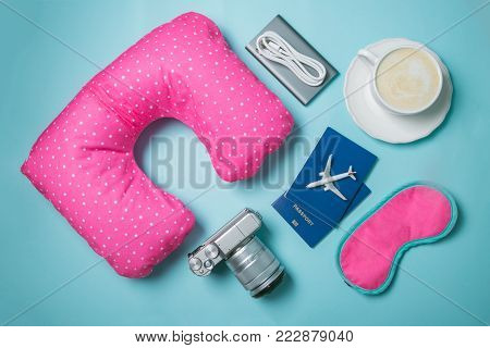 Traveling concept - traveling essencials on blue background, top view
