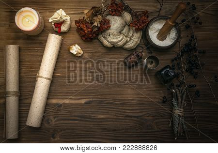 Ancient magic scroll on wooden desk table. Witchcraft. Witch doctor desk table. Magic potion. Alternative medicine concept.