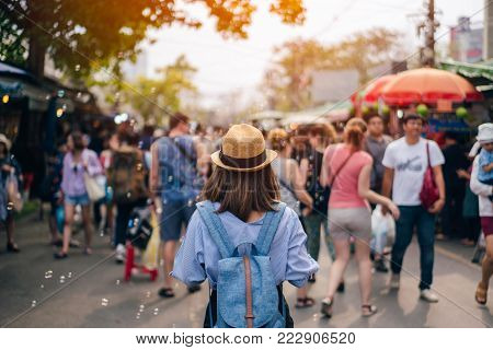 Young Woman Traveler With Sky Blue Backpack And Hat Looking The Way With In Jj Market In Bangkok Tha