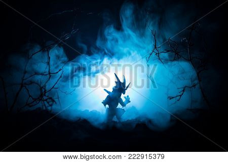 Silhouette Of Fire Breathing Dragon With Big Wings On A Dark Blue Cold Background