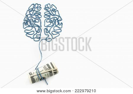 Brain and money connected by a thread on a white background