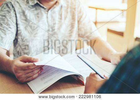 High School Or College Students Studying And Reading Together In Library