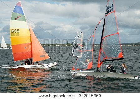 Lake Macquarie, Australia - April 16, 2013: Children Sailing Under Supervision Competing In The Aust