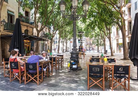 Tourists Enjoying The Sant Agusti Vell Square, In The Center Of Barcelona, In The Gothic And Borne N