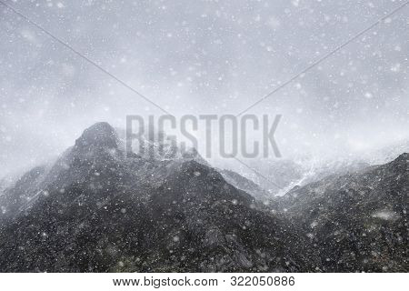 Stunning Moody Dramatic Winter Landscape Mountain Image Of Snowcapped Y Garn In Snowdonia