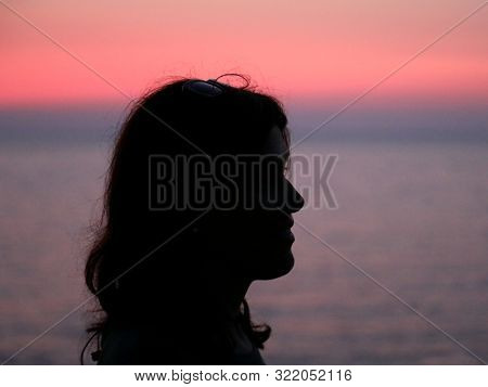 Black Profile Of Young Woman With Long Hair At Sunset