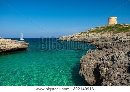 View On The Beach Calo Roig With Crystal Water, White Boat And The Defense Tower Torre De Defensa De