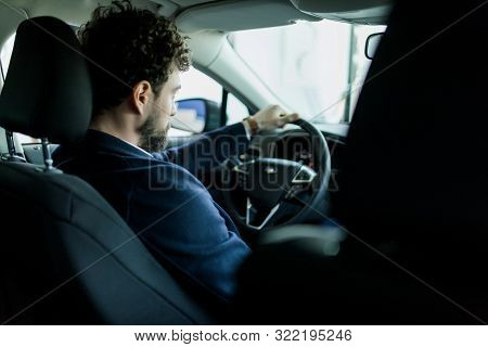 Happy Car Owner At The Dealership. Handsome Young Men Sitting At Front Seat Of The Car