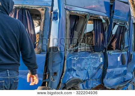 A Rumpled Blue Minibus Is On The Road After An Accident. Accident On The Road In The City On A Sunny