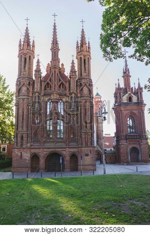 VILNIUS, LITHUANIA - JULY 30, 2019:  Facade of Roman Catholic Church of St. Anna in Vilnius (lit. Church of the Holy Onos) and  Church Of St. Francis And St. Bernard, UNESCO World Heritage