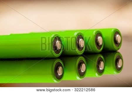 Close-up Of Green Alkaline Batteries. Close Up Colorful Rows Of Aa Batteries Energy Background Selec