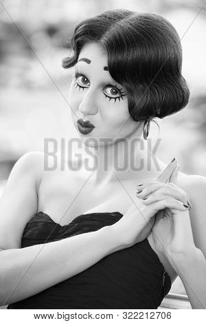 Fun Young Woman With Vintage Pinup Makeup Making Dolly Face Looking At Camera, Monochrome