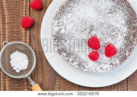 Chocolate Sticky Brownie Cake, Swedish Dessert Kladdkaka, On The Plate, Garnished With Icing Sugar A