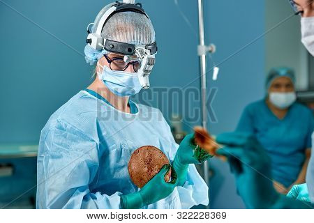 Surgeon Preparing Breast Silicone Implant For The Operation