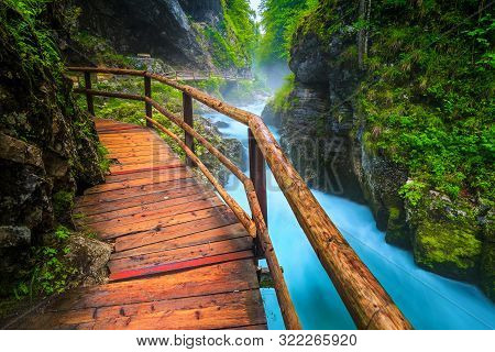 Admirable And Well Known Touristic Attraction Near Bled. Amazing Vintgar Gorge With Wooden Footbridg