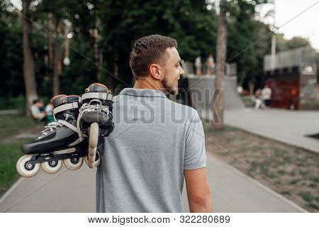 Roller skating, skater carries skates on shoulder