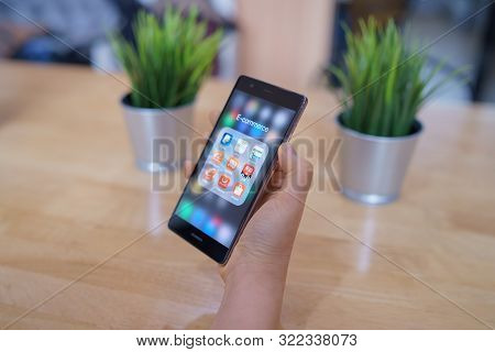 Chiang Mai, Thailand - Feb. 18,2019:  Woman Holding Huawei With Icons Of E-commerce And Online Shopp