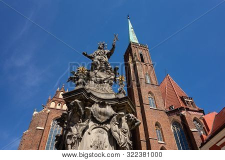 The Statue Of John Of Nepomuk (swietego Jana Nepomucena) In Front Of The Collegiate Church Of The Ho
