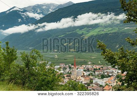 The City Of Schlanders (south Tyrol, Italy) From Above On A Cloudy Day In Summer