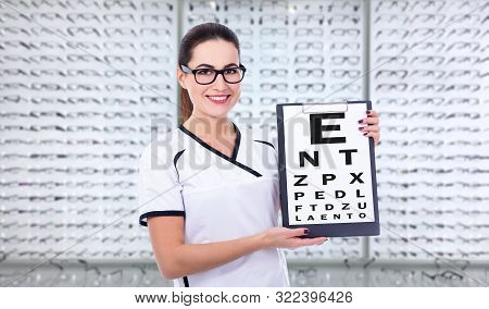 Eyesight And Vision Concept - Young Woman Optometrist Or Consultant Holding Clipboard With Eyevision