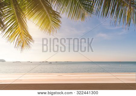 Wooden Table With Coconut Plam Tree And Sunset At Tropical Beach, Summer Vacation Concept