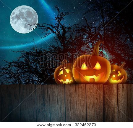 Sppoky Halloween Pumpkins On Wood. Halloween Background At Night Forest With Moon.