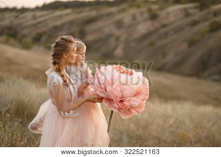 Mom With Daughter In Pink Fairy-tale Dresses Walk In Nature. The Childhood Of The Little Princess. L