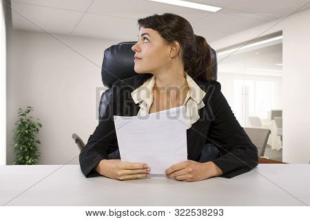 Young Female Business Employee Newly Hired Or A Student Doing Writer Internship.  She Is In A Workst