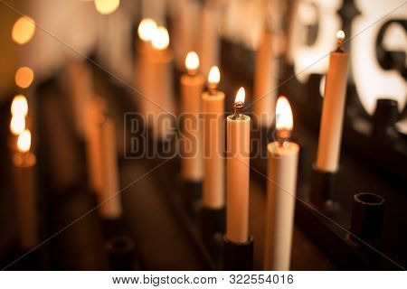Color Image Of Rows Of Candles Burning In A Church.