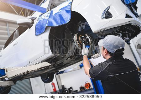 Asian Male Car Technician Car Maintenance For Customers According To Specified Vehicle Maintenance C