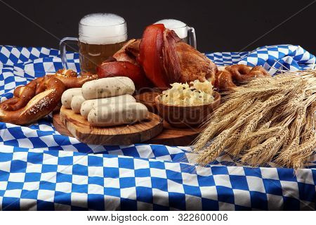 Traditional German Cuisine, Schweinshaxe Roasted Ham Hock. Beer, Pretzels And Various Bavarian Speci
