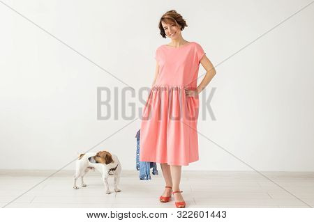 Pets Owner Concept - Young Woman In Pink Dress With Jack Russell Terrier Dog Over The White Backgrou