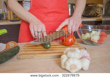 Chef Cuts The Vegetables Into A Meal. A Woman Uses A Knife And Cooks. Woman's Hands Cutting Vegetabl