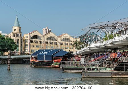 Singapore - March 21, 2019: Closeup Of Boats On Singapore River At North Boat Quay With Its Bars And