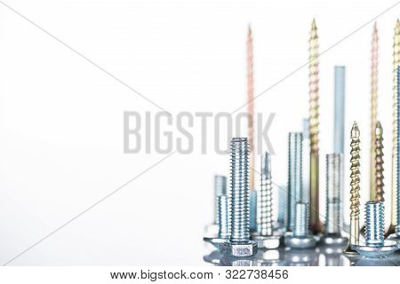 Shiny Steel Bolts And Studs Isolated On White