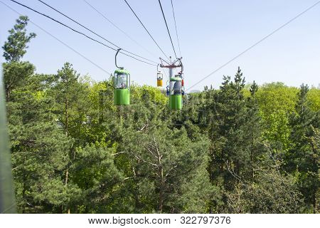 Kharkov, Ukraine - April 30, 2018: Colourful Cabins On Rope In The City Park. Panorama Of Cablecars 