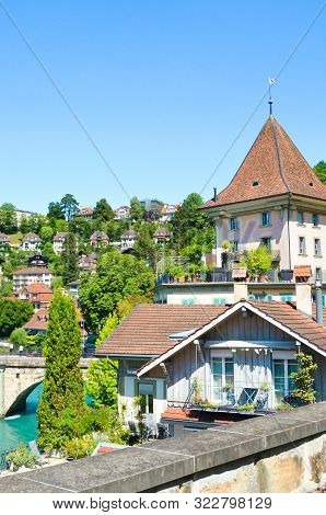 Bern, Switzerland - August 14, 2019: Historical Buildings Located Along Turquoise Aare River In The 