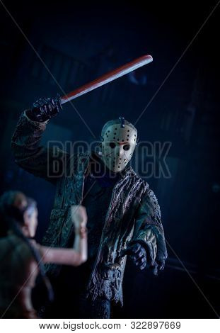 SEPT 17 2019: Horror movie slasher Jason Voorhees hacking a victim at Camp Crystal Lake - Neca Jason action figure