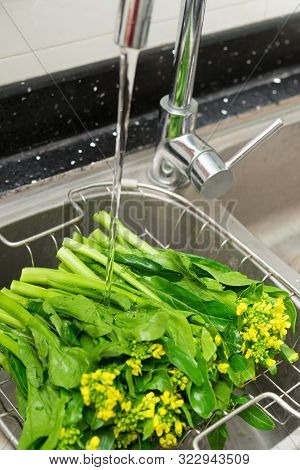 Washing Fresh Vegetable On Sink Vertical Composition