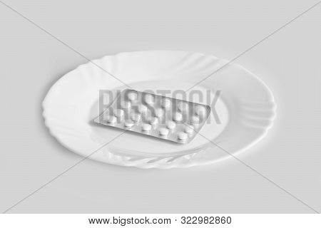 Different Pills On A Plate. The Concept Of Prescription Drugs For Weight Loss. Means For Suppressing
