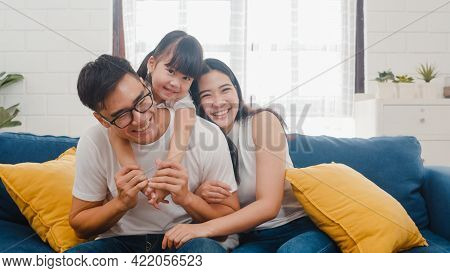 Happy Cheerful Asian Family Dad, Mom And Daughter Having Fun Cuddling And Video Call On Laptop On So