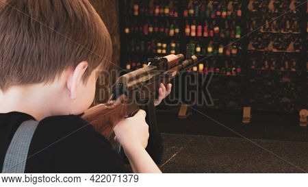 The Kid On The Shooting Range Shoots At Targets