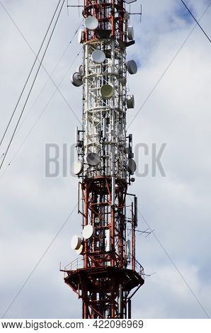 The Plot Of The Tower Close-up. Tv Tower Against A Cloudy Blue Sky.