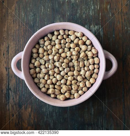 Pink Plate With Chick Peas On Wooden Background - View From Above