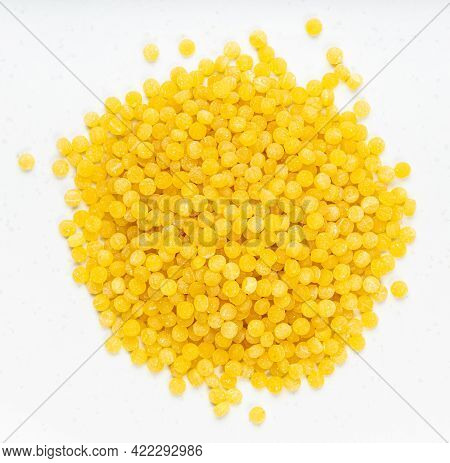 Top View Of Pile Of Uncooked Ptitim Pasta (israeli Couscous) Close Up On Gray Ceramic Plate